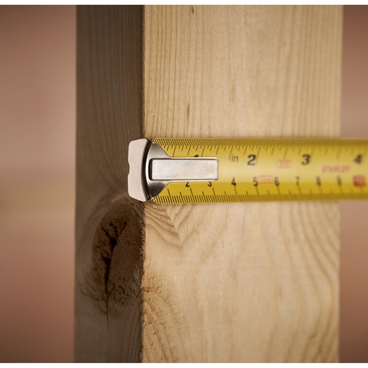 STANLEY 0-33-443 tape measure measuring wooden beam, close-up photography.