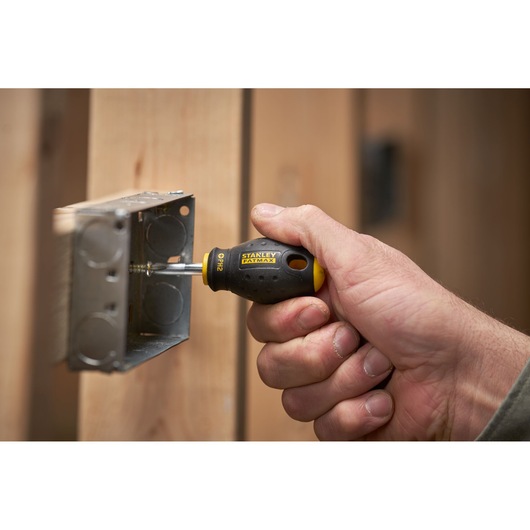 Photo of STANLEY 0-65-407 FATMAX screwdriver in use tightening metal box screw.