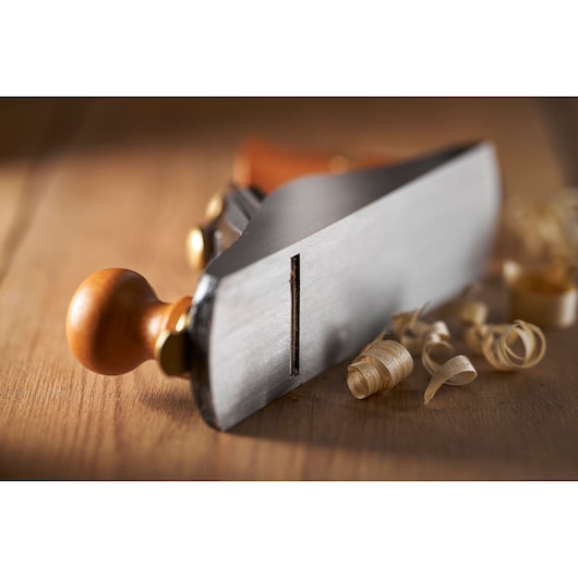 STANLEY 1-12-136 woodworking hand plane photographed close-up on wooden surface with wood shavings.