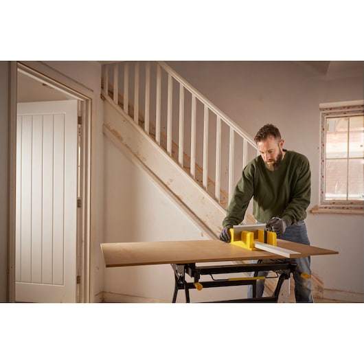 STANLEY 1-20-600 photography of yellow miter box on wooden board used for precision sawing indoors.