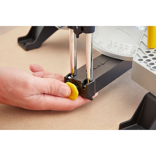 STANLEY 1-20-800 photography of hand adjusting yellow knob on mitre box, close-up angle.