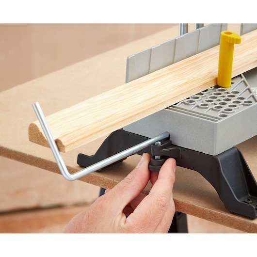 STANLEY 1-20-800 miter box with saw guide, wood piece positioned, close-up angle on white background.