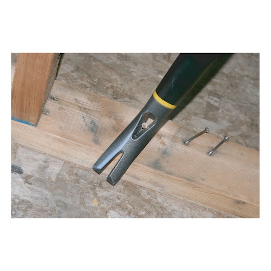 STANLEY 1-55-099 pry bar with yellow and black handle removing a nail from a wooden board, nails nearby.