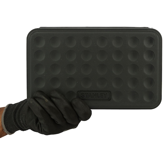 Photo of STANLEY 1-89-099 black case with textured dots, held in hand, front angle.