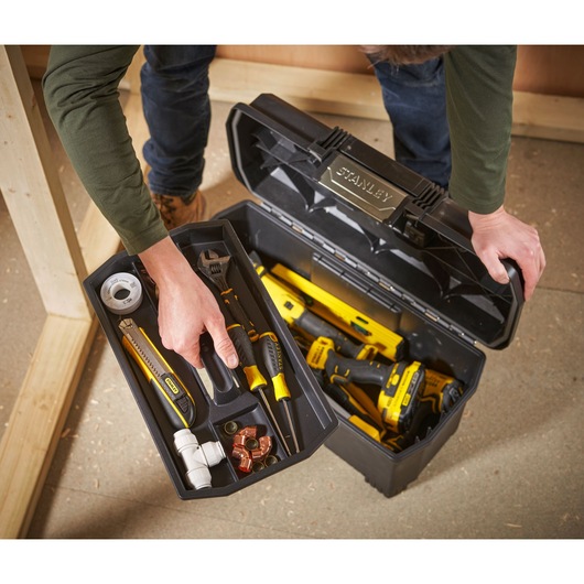 STANLEY 1-97-510 toolbox open, showing assorted hand tools and power tools inside, viewed from above.