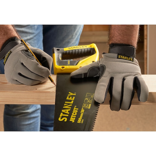 STANLEY 2-20-151 hand saw and gloves marking wood, close-up photography.