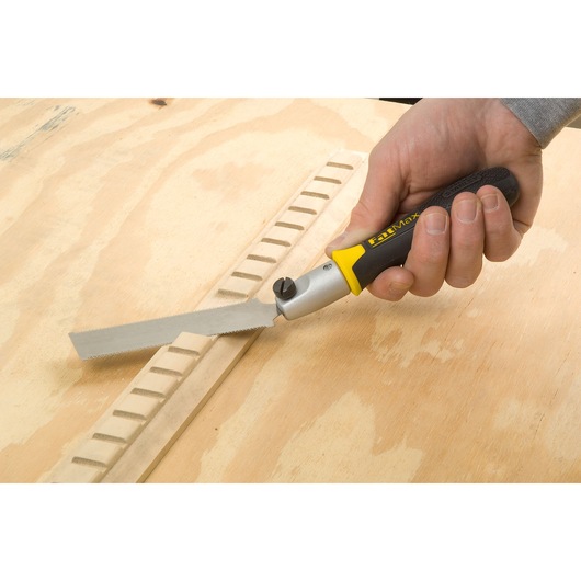 STANLEY 3-20-331 folding saw with black and yellow handle used on wood surface, close-up photo.