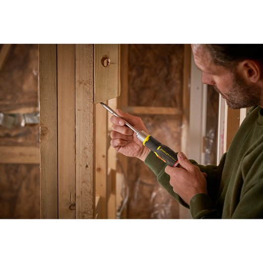 Photo of STANLEY FMHT0-62691 screwdriver used on wooden frame in construction setting.