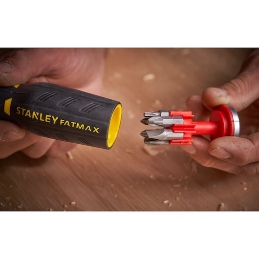 STANLEY FATMAX FMHT0-62691 screwdriver handle with yellow inner, showing red bit holder with multiple bits, close-up.