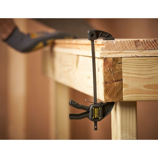 STANLEY FMHT0-83231 photography of bar clamp securing wooden workbench edge
