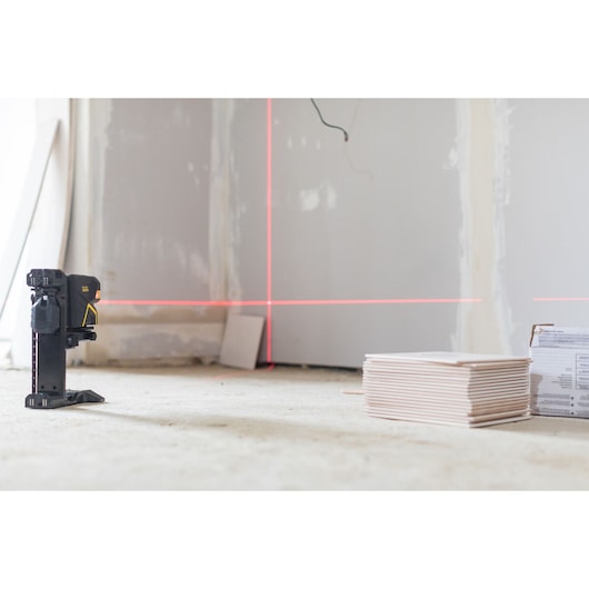 STANLEY FMHT1-77415 laser level projecting lines in a construction room, low angle photography.
