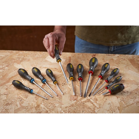 Photo of STANLEY FMHT65426-0 screwdriver set with black handles on wooden surface.