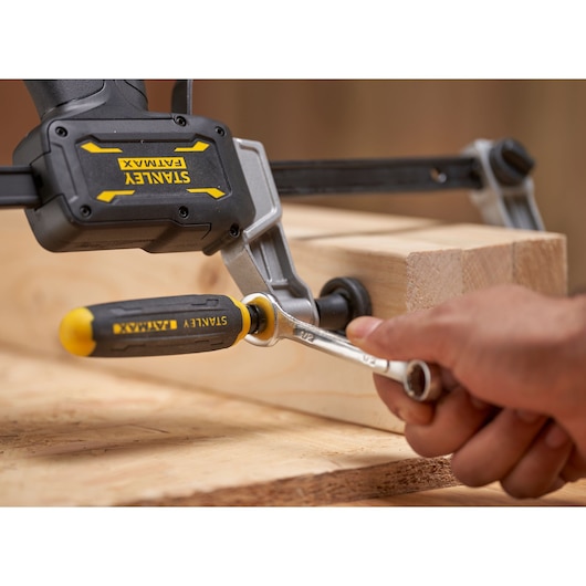 Photo of STANLEY FMHT83007-0 clamp with yellow and black handle securing wooden boards.