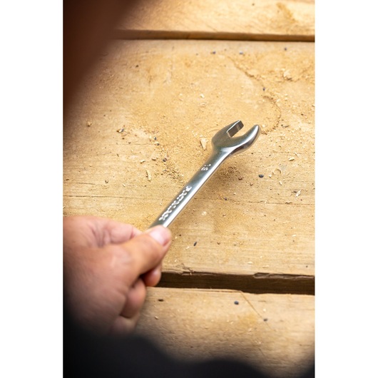 Photo of STANLEY FMMT13033-0 open-end wrench held by hand on a wooden surface.