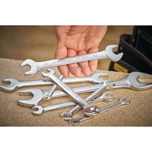 STANLEY FMMT13077-0 photography of silver open-end wrenches, one held by hand, on a work surface.