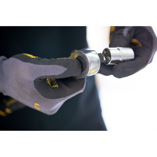 STANLEY FMMT17216-0 socket attachment held by gloved hands, close-up photography.