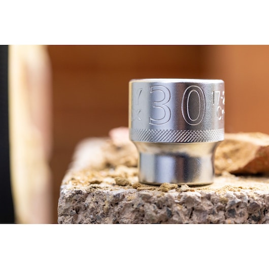 STANLEY FMMT17245-0 socket, silver, 30mm, close-up angle, photography on rough surface.
