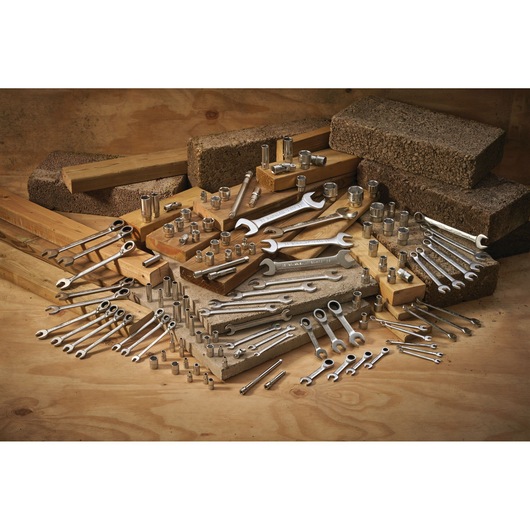 STANLEY FMMT17249-0 photography of assorted wrenches and sockets displayed on wood and stone blocks.