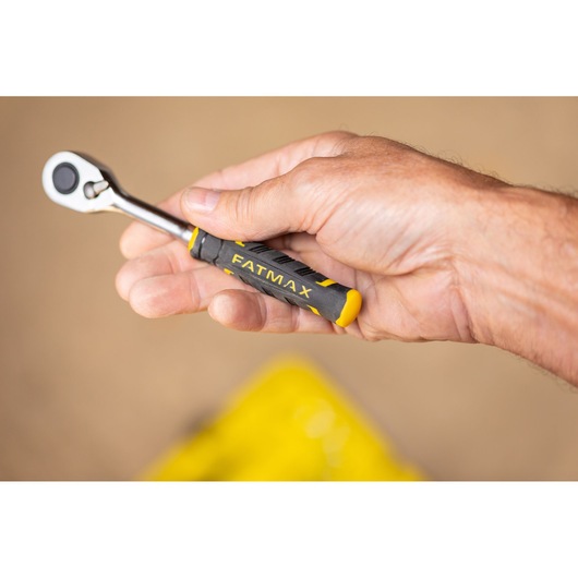 STANLEY FMMT82676-0 ratchet tool with FATMAX handle held in hand, photography close-up.