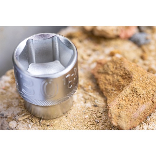 STANLEY FMMT82680-0 socket tool close-up, silver finish, placed on rough sandy surface.