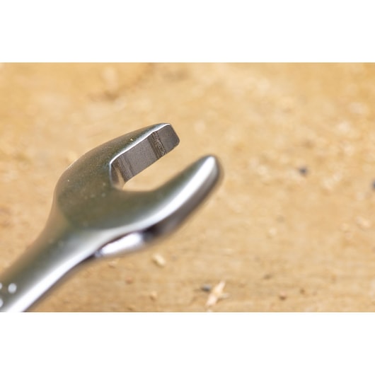 STANLEY FMMT82845-0 photography of open-end wrench head on wood surface, close-up angle.