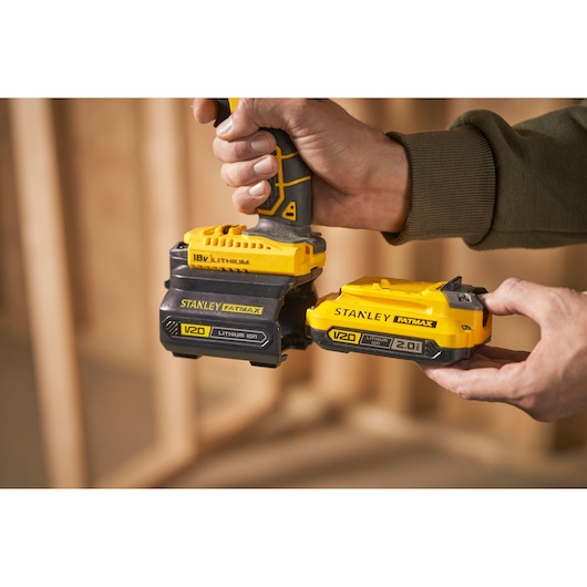 Photo of STANLEY FATMAX V20 lithium ion batteries, SKU SFMCB100, being attached to a power tool.