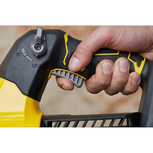 STANLEY SFMCBLB76B blower handle close-up showing hand gripping trigger and speed control.