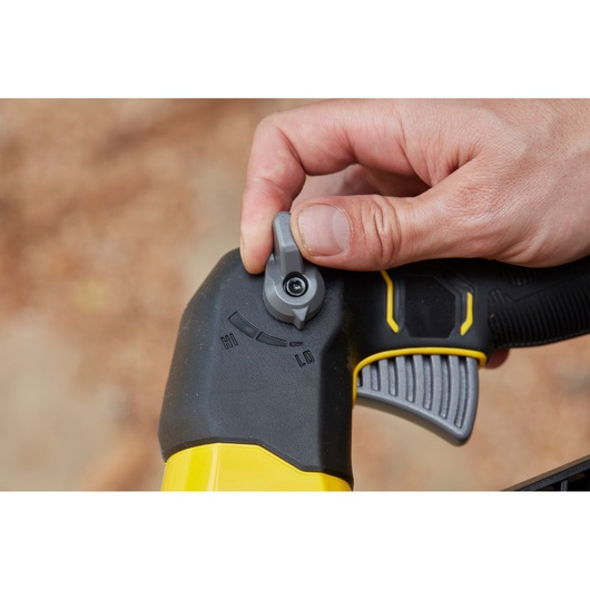 STANLEY SFMCBLB76B blower handle close-up with speed control dial, black and yellow, hand adjusting setting.