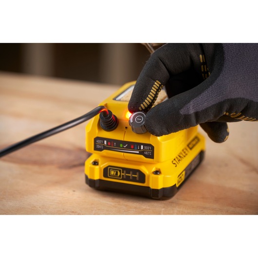 STANLEY SFMCE040B heat gun base with glove adjusting temperature knob, product close-up photo.