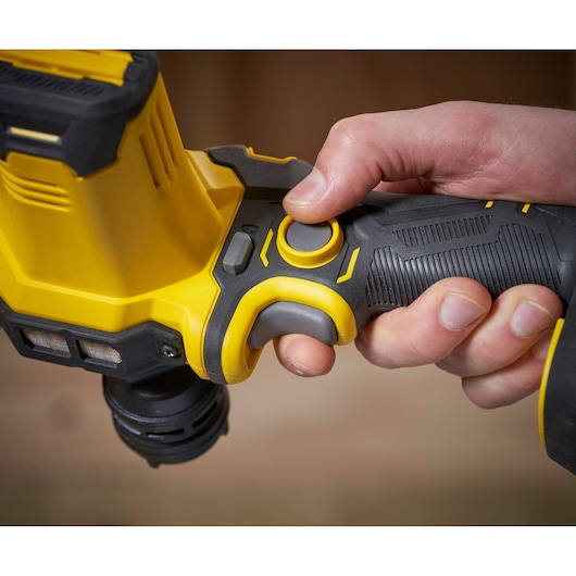 STANLEY SFMCE210D2 rotary drill handle close-up held by hand, showing yellow and black controls.