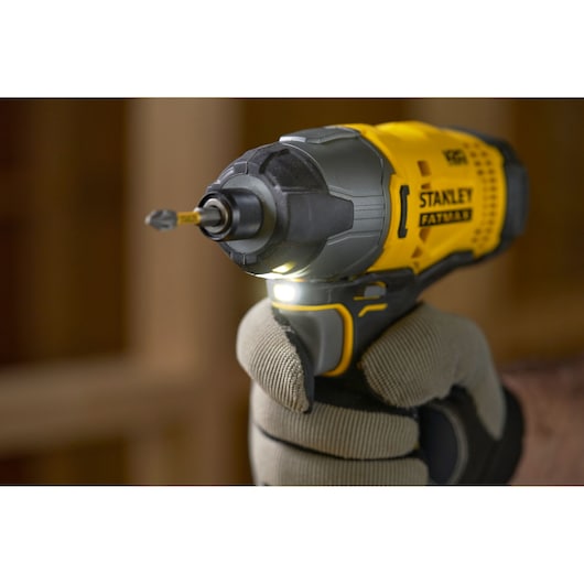 Stanley SFMCF800C2K impact driver close-up in use, yellow and black body, photographed from front side.