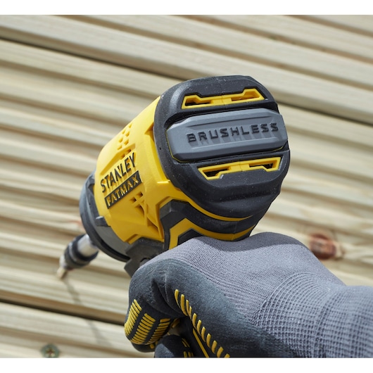 STANLEY SFMCF820D2K impact driver, brushless, close-up in use, yellow and black casing.