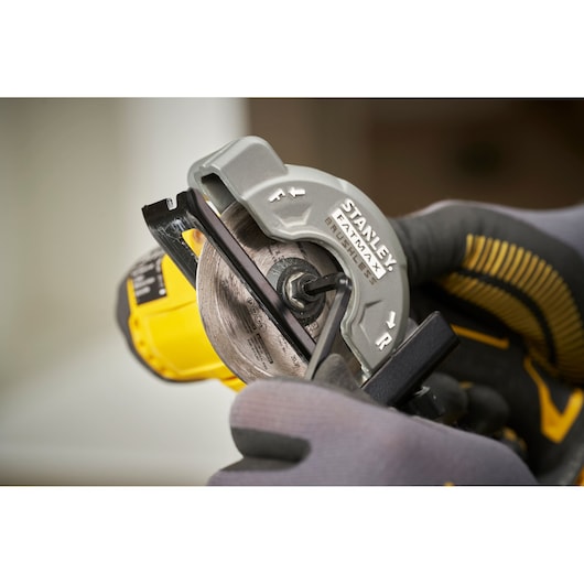 STANLEY SFMCM300D2 circular saw close-up with glove, showing blade and guard in use.
