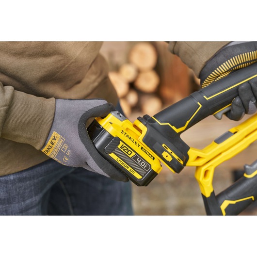Photo of STANLEY SFMCPS515M1 tool with V20 4.0Ah lithium-ion battery, close-up showing battery installation.