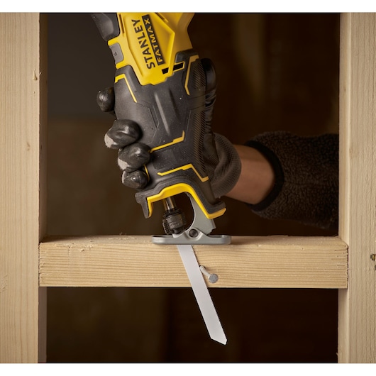 STANLEY SFMCS310D2K cordless reciprocating saw cutting wood, close-up angle, product in use.