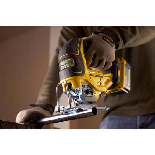 Photo of STANLEY SFMCS650M2K 18V STANLEY FATMAX V20 Brushless Jigsaw cutting metal pipe, shown in use.