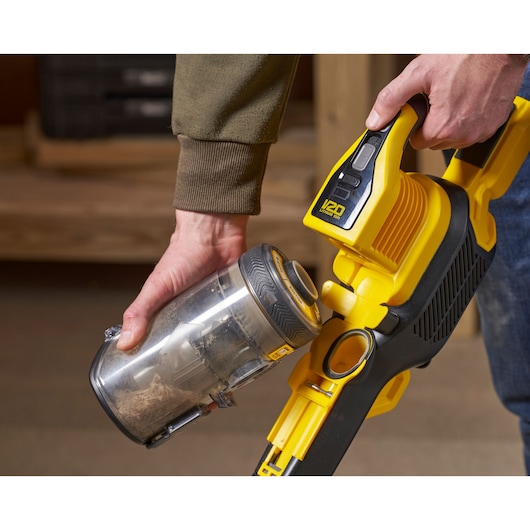 STANLEY SFMCVS001D1 cordless vacuum cleaner close-up with dust container being removed.