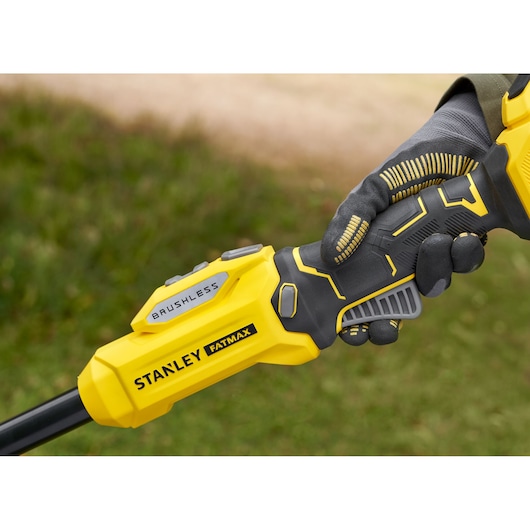 Photo of STANLEY SFMSTB930B brushless FATMAX tool handle held by gloved hand outdoors.