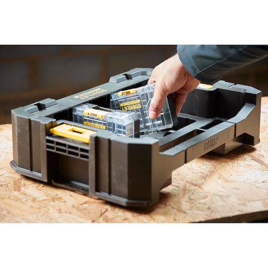 STANLEY STA88558 organizer tray with clear and yellow containers on wood surface, hand lifting one box.