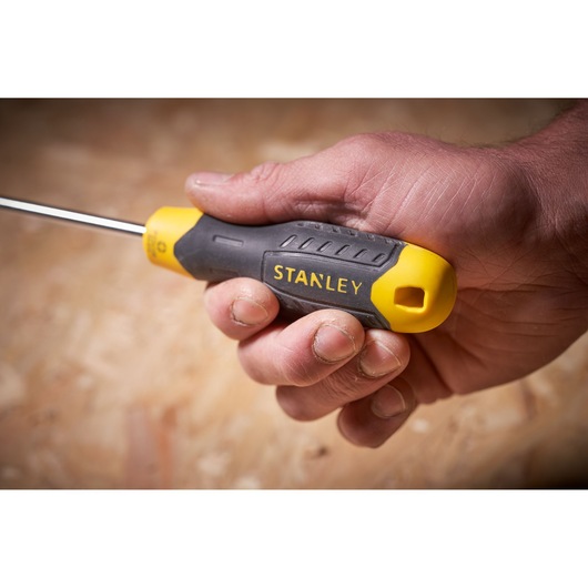 Photo of STANLEY STHT0-60276 screwdriver with yellow and black handle held in hand.