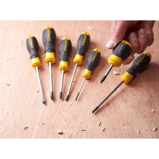STANLEY STHT16196-0 screwdriver set with black and yellow handles, shown on a wooden surface.