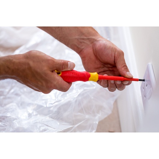 Photo of STANLEY STHT60030-0 insulated screwdriver in use installing a socket cover.