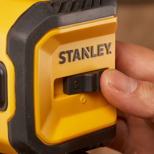 Photo of STANLEY STHT77611-0 yellow tool with black lock switch, close-up, product category: Photography.