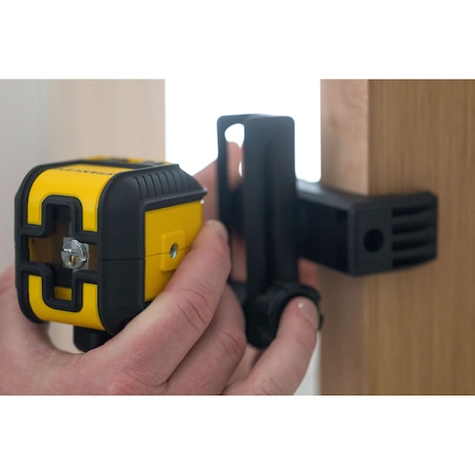 STANLEY STHT77649-1 yellow and black laser level mounted on bracket, close-up view.