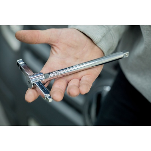STANLEY STHT80872-0 chrome T-handle tap wrench held in hand, close-up photography.
