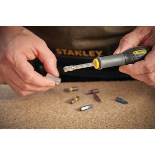 Photo of STANLEY STMT13910-0 screwdriver with magnetic bits shown on work surface.