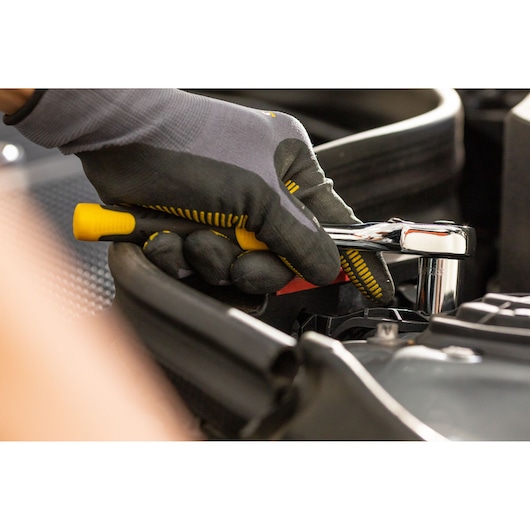 STANLEY STMT86312-0 ratchet wrench used in automotive repair, close-up photography of gloved hand.