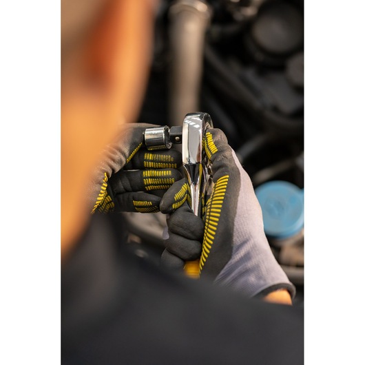 Photo of STANLEY STMT86519-0 ratchet being used with gloves near engine, product category: photography.