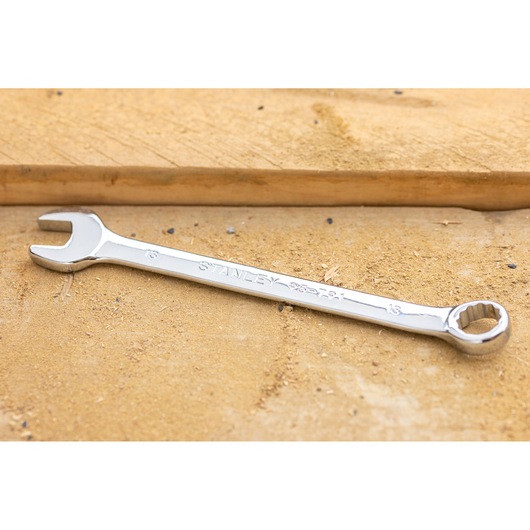 STANLEY STMT95788-0 combination wrench, silver finish, lying flat on sandy work surface.