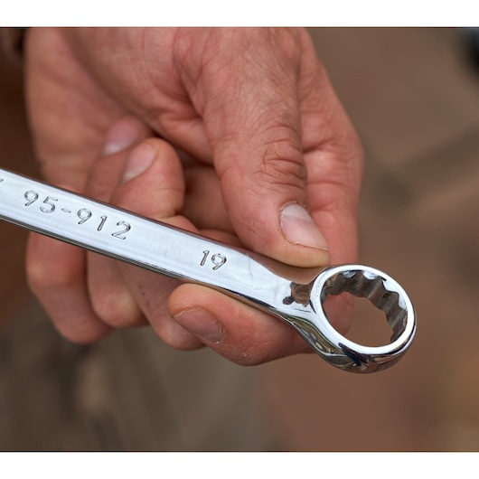 Close-up of hand holding STANLEY STMT98109-1 ring spanner, part of STANLEYMaintenanceSuitcase142PCS.
